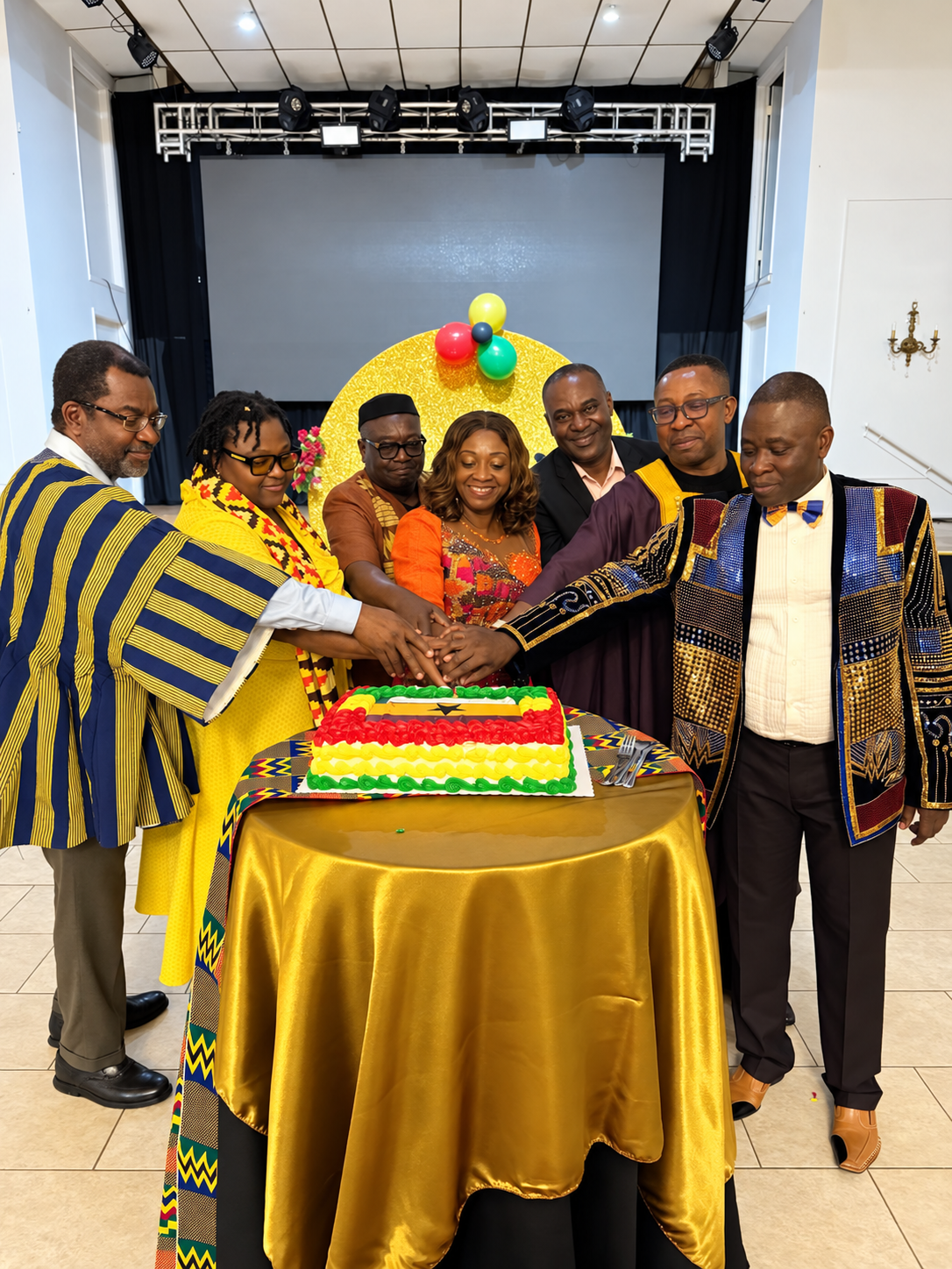 Ghana Day organizers and community members gathered around a celebration cake
